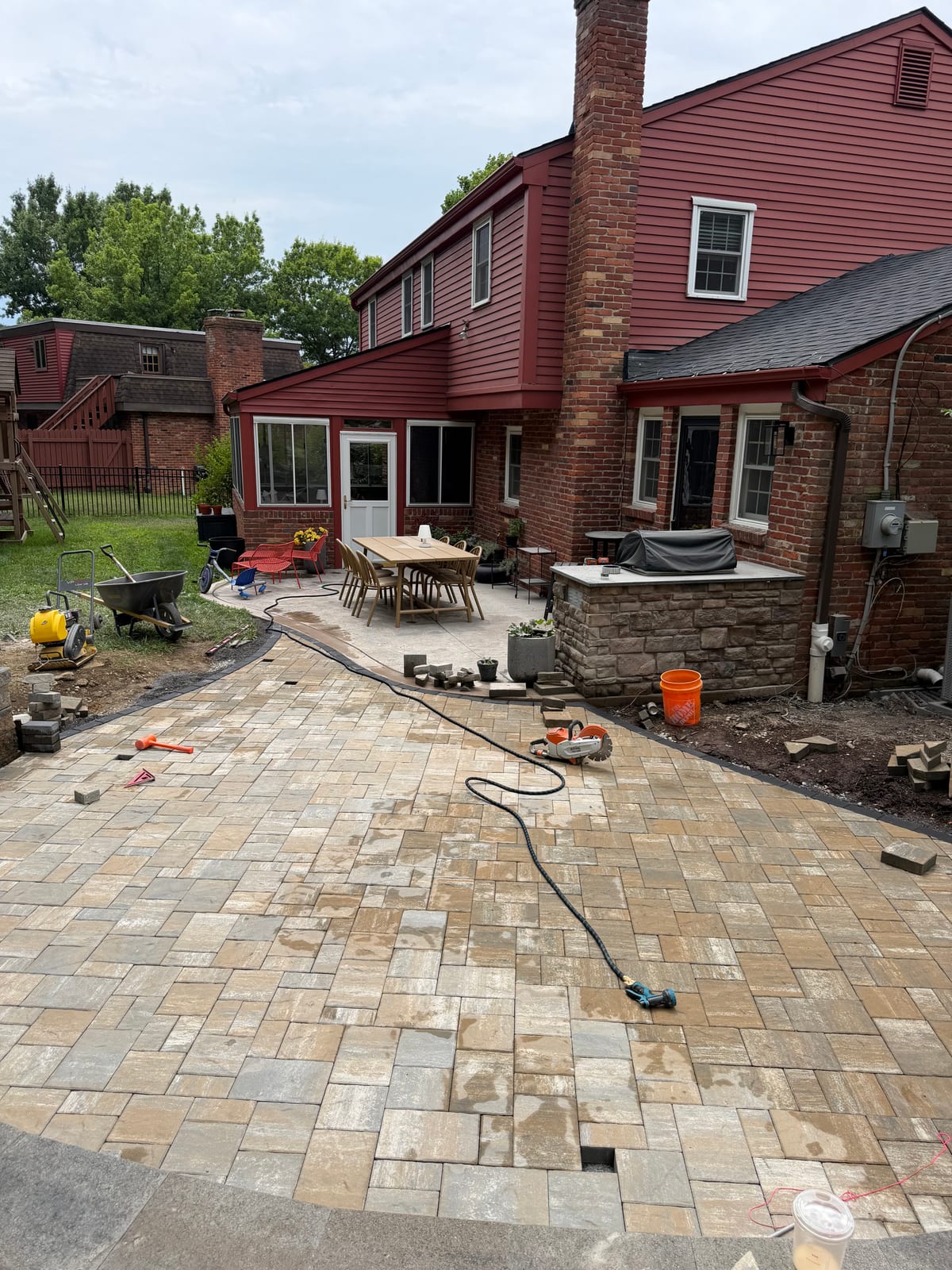 New paver patio installation taking shape behind a brick home in McDonald, PA