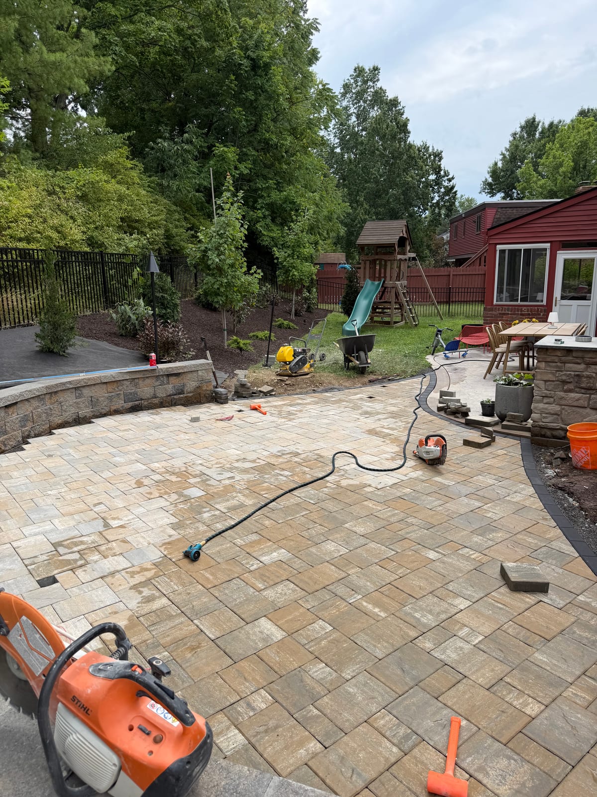 Paver patio installation in progress in a McDonald, PA backyard by Betschart Lawn and Landscape